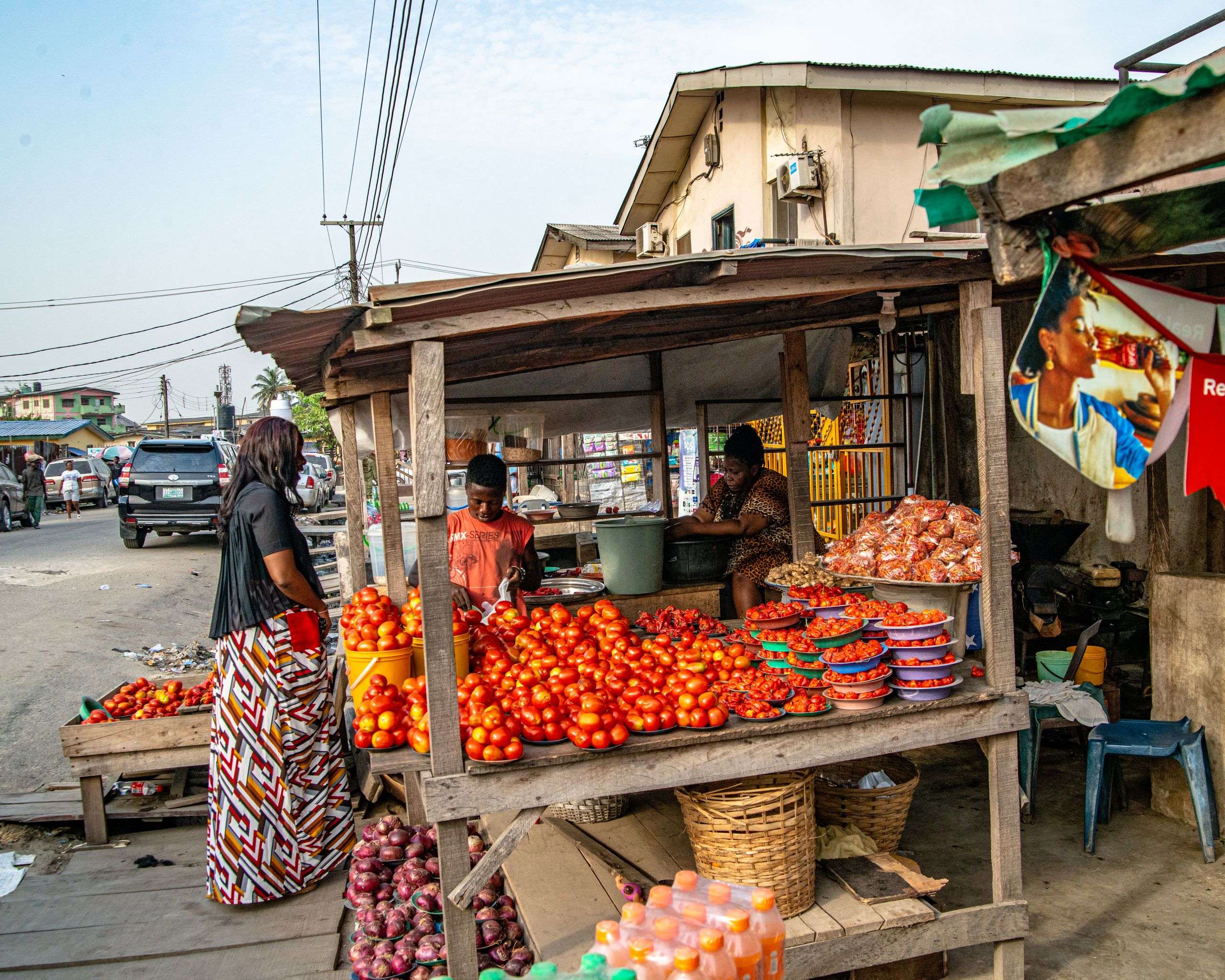 Street market stall stacked with fresh tomatoes