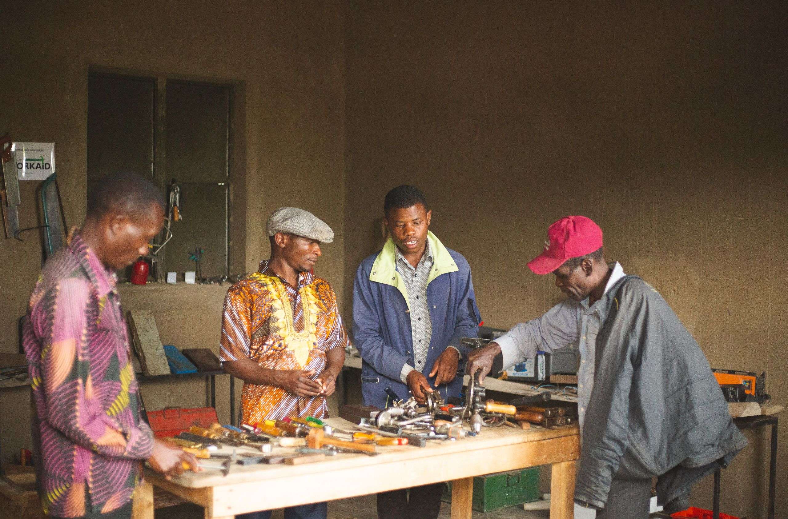 Group of men collaborating in a workshop in Uganda