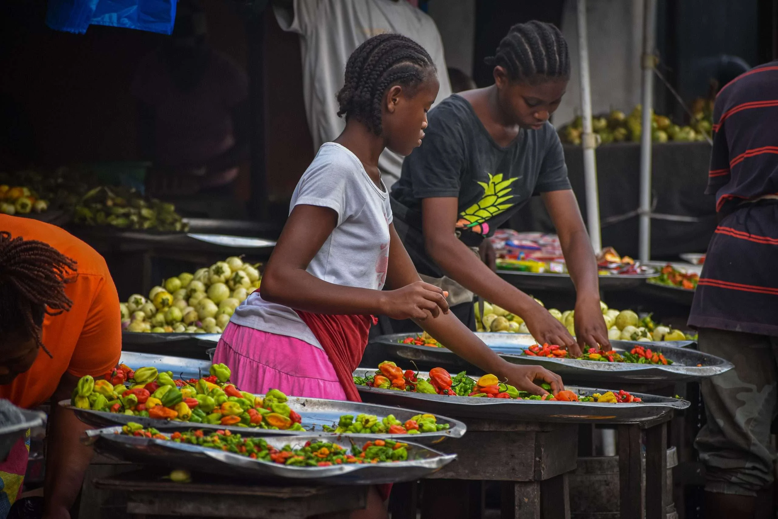 Women sorting produce at a market