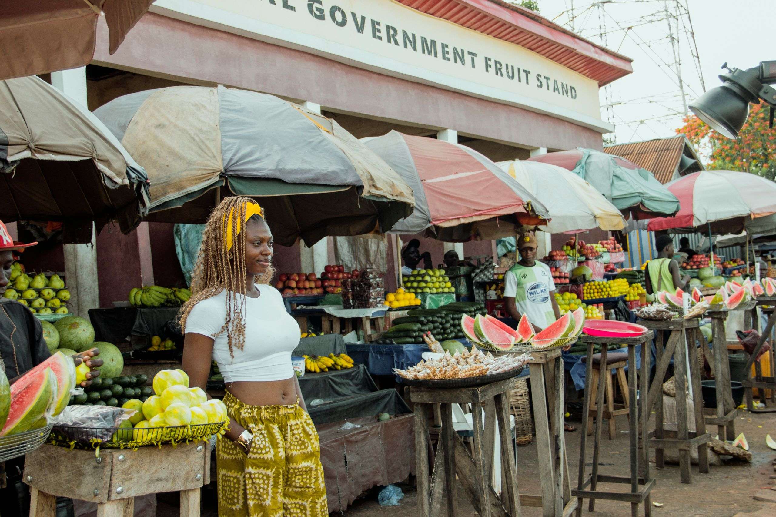 Outdoor fruit market with vendors and fresh produce in Africa